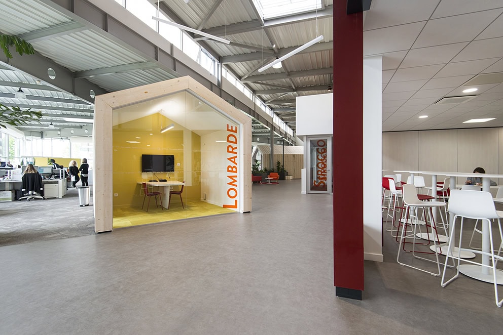 photo montrant un open space et une petite salle de réunion